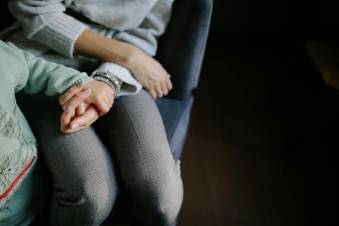 moeder en kind houden elkaars hand vast